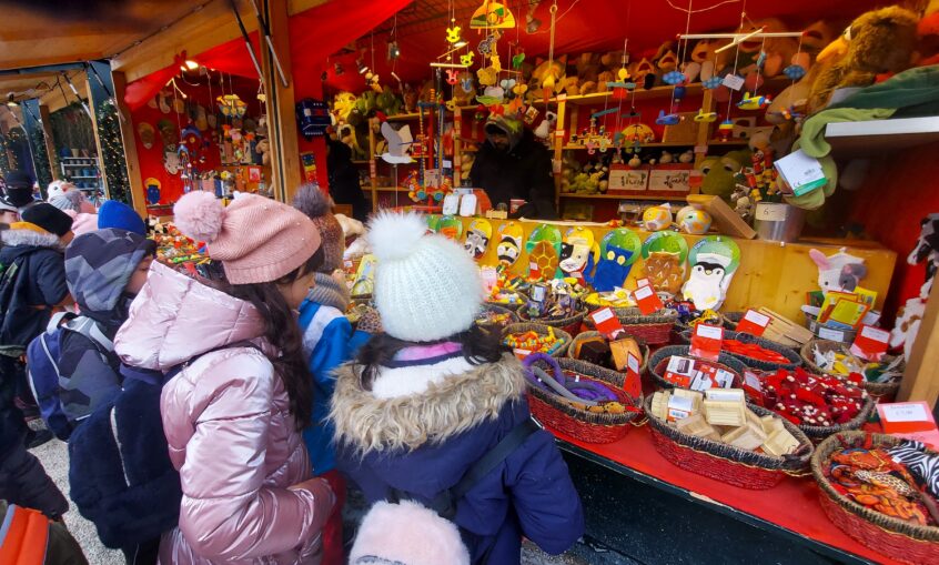 girls looking at ornaments at a Christmas market